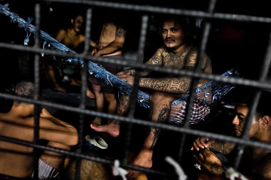 A member of the 18th Street gang (M-18) sits in a homemade hammock in a cell at the detention center in San Salvador, El Salvador.