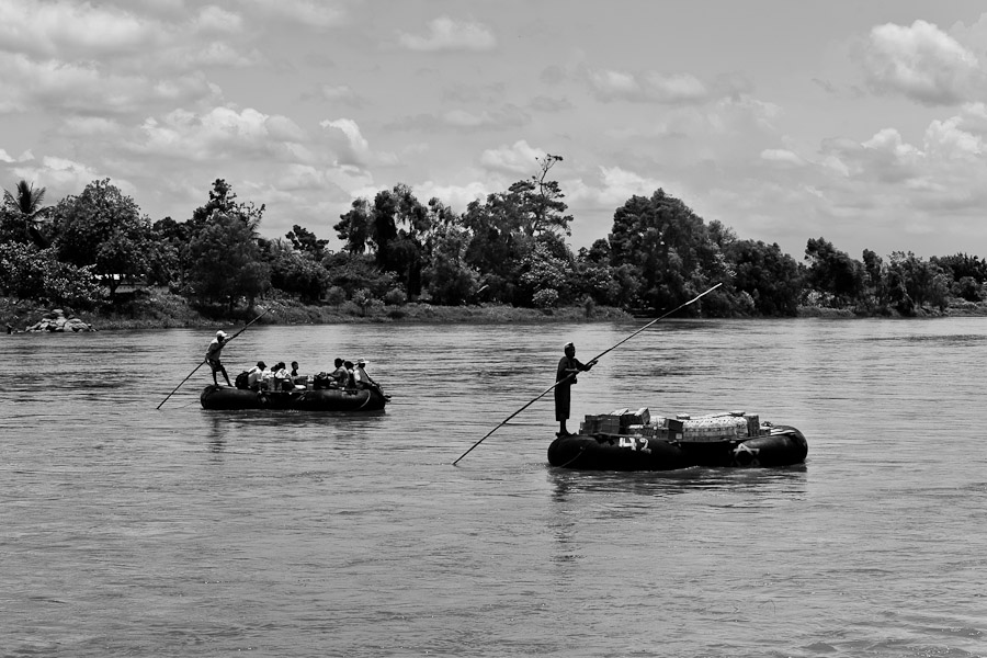 Makeshift inner tube rafts, carrying smuggled goods and border area workers, cross the Suchiate river from Mexico to Tecún Umán, Guatemala.