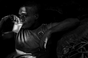 Charcoal worker drinks milk (Cartagena, Colombia)