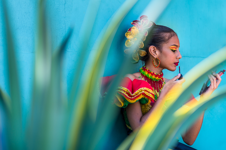 A Colombian girl finishes her makeup before taking part in the Carnival parade in Barranquilla, Colombia.