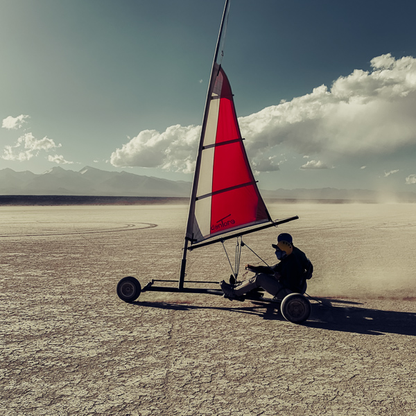 An Argentine pilot steers a land yacht while sailing with a passenger across the lake bed of Barreal Blanco in the province of San Juan, Argentina.