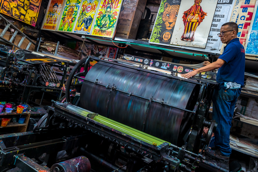 A Colombian master printer works on the historical letterpress machine at a printing workshop in Cali, Colombia.