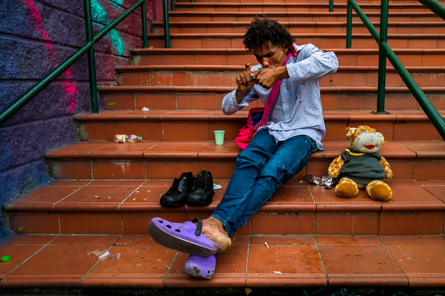 A Colombian drug addict smokes a pipe of “basuco” (semi-refined cocaine paste) on the street in the center of Medellín, Colombia.