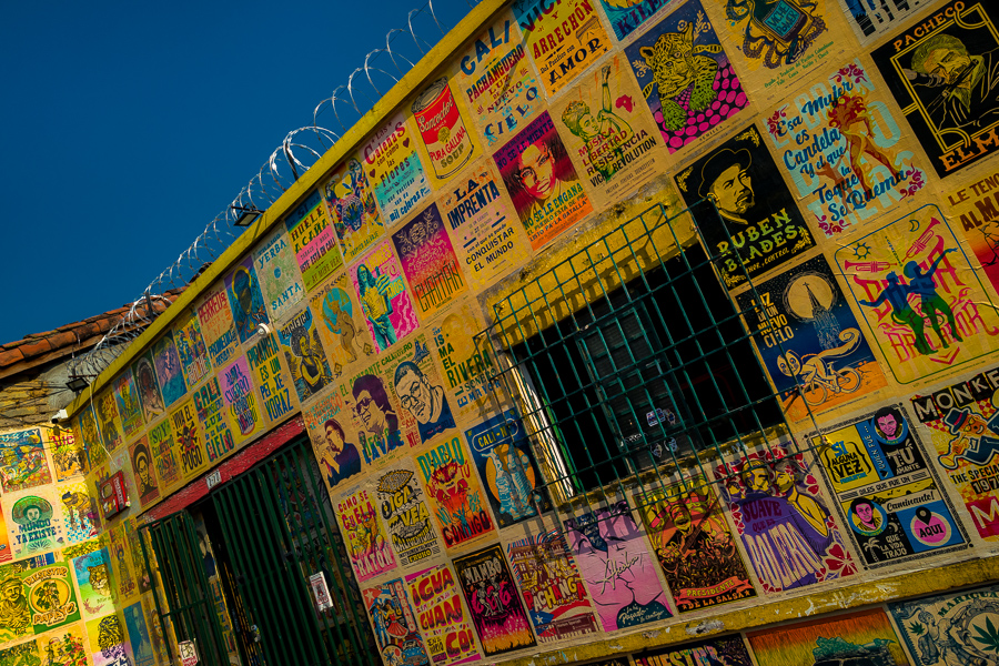Typographic and lino print posters are seen decorating the front wall of an antique printing workshop in Cali, Colombia.