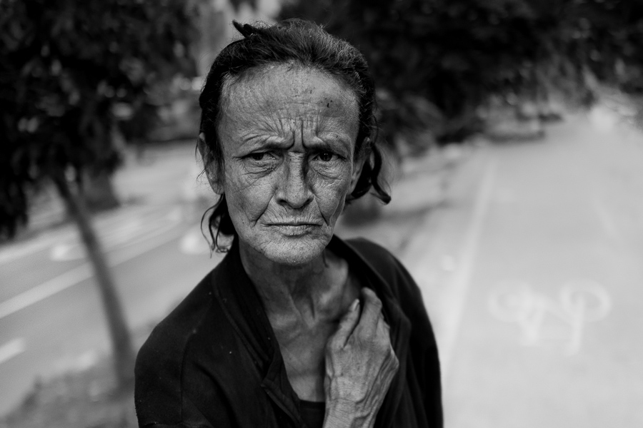 A Colombian woman, living and working on the streets, poses for a picture in the center of Medellín, Colombia.