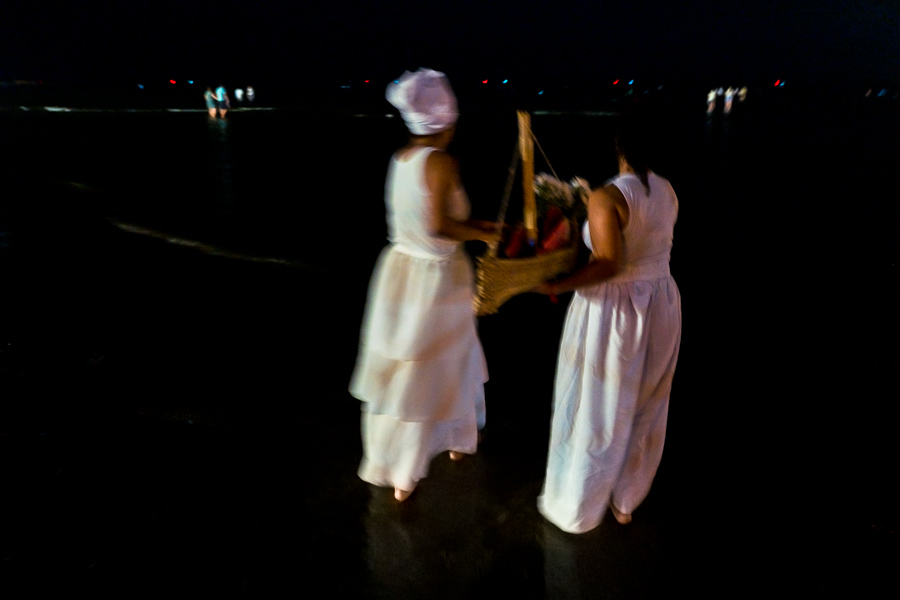 Devotees of Umbanda, the Afro-Uruguayan religious tradition, carry a paper boat during a ritual ceremony in honor of the goddess Yemanjá on the seashore in Montevideo, Uruguay.