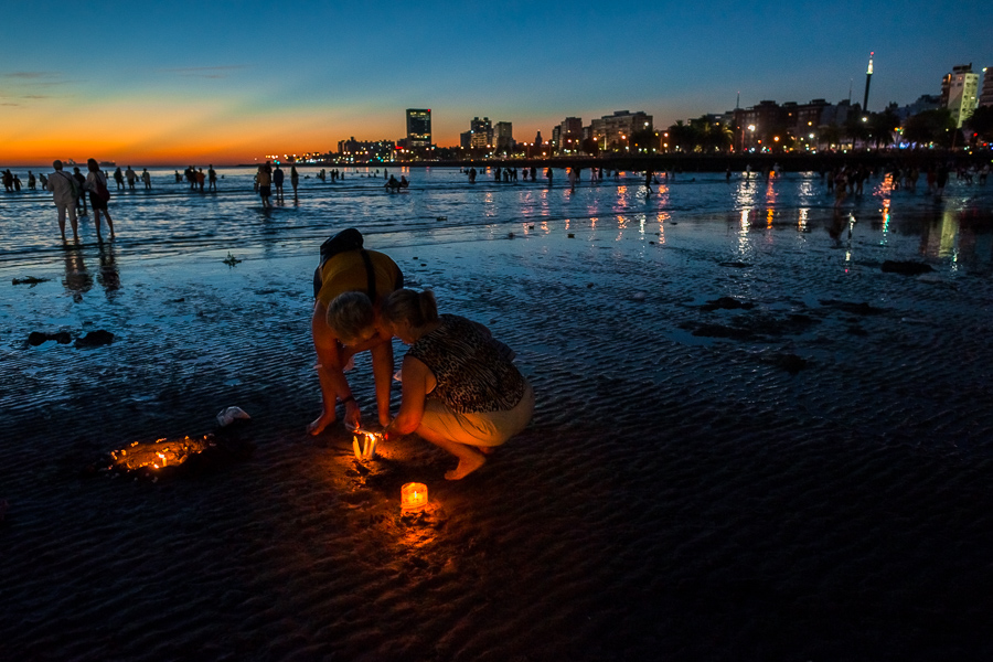 Worshipers light candles to pay tribute to Yemanjá, the African-inspired goddess, during a ritual ceremony on the seashore in Montevideo, Uruguay.